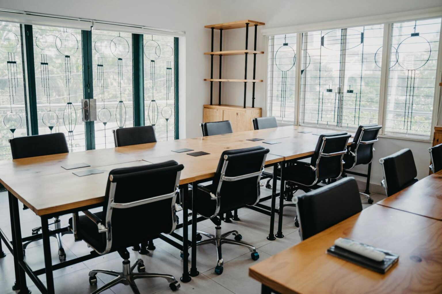 Office conference room. Long table with black chairs