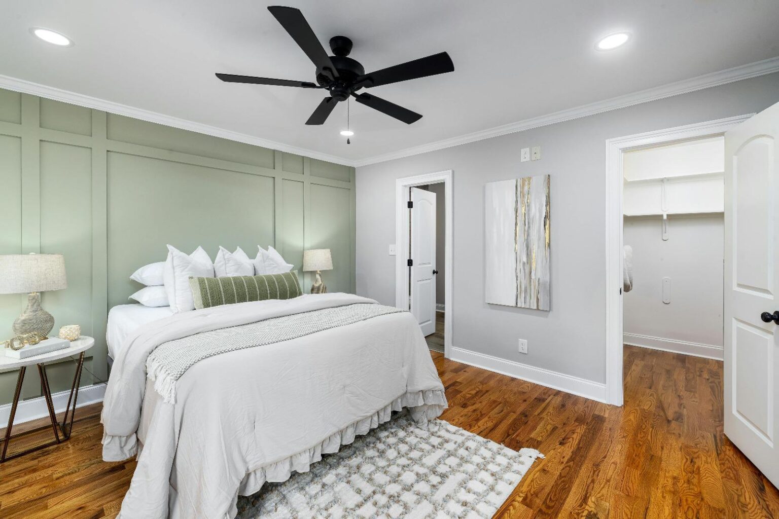 Bedroom with a green accent wall. The best house cleaning service in Portsmouth