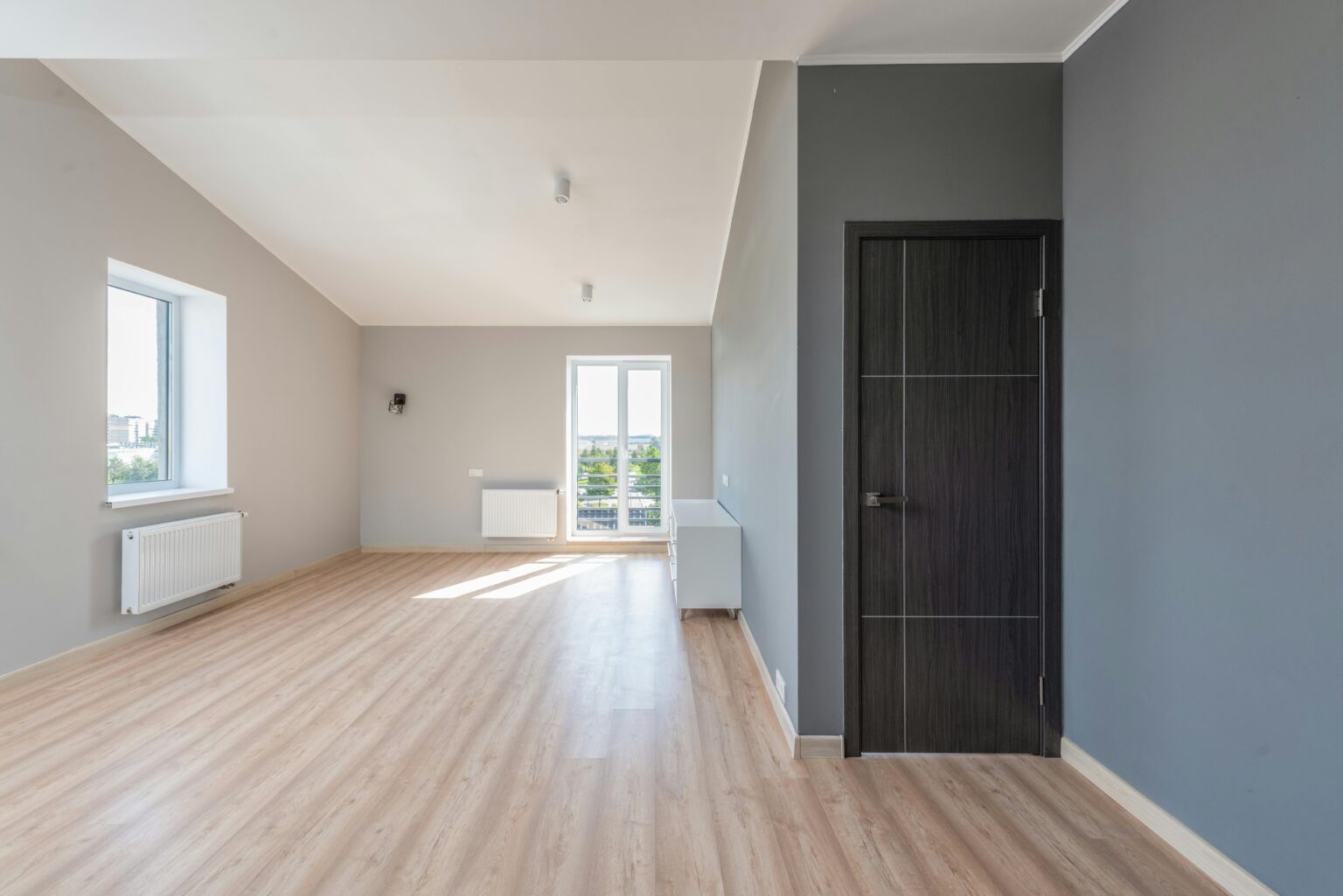 empty room with a black door and blue accent wall