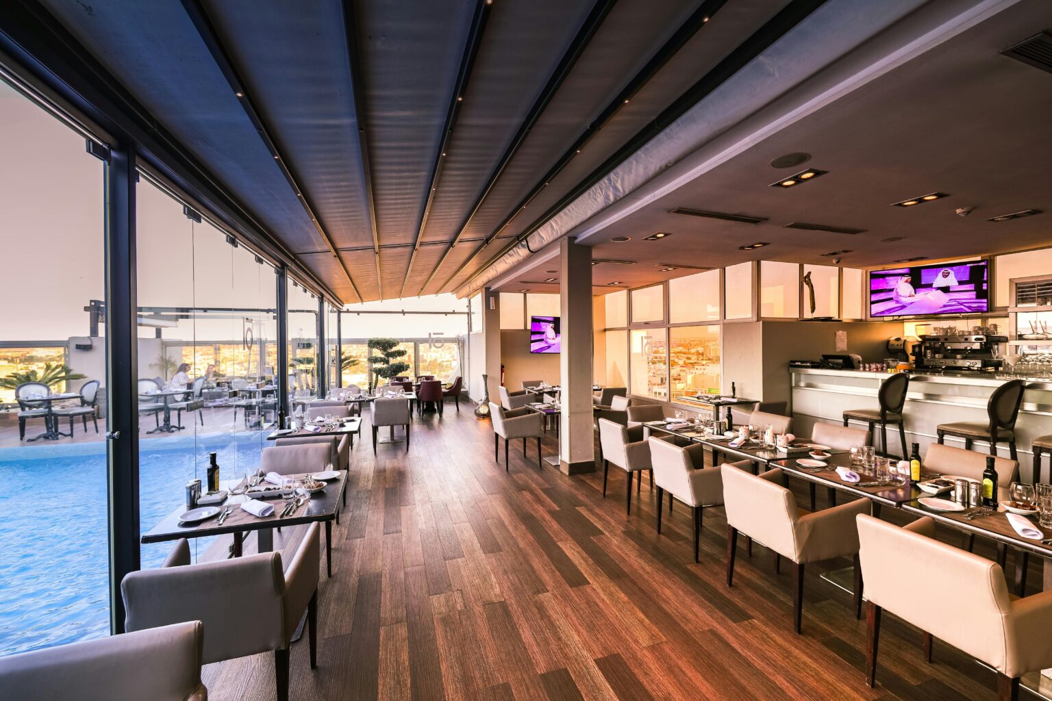 The best commercial cleaning services in Hampton. Restaurant area with large windows to the left and an outdoor pool.