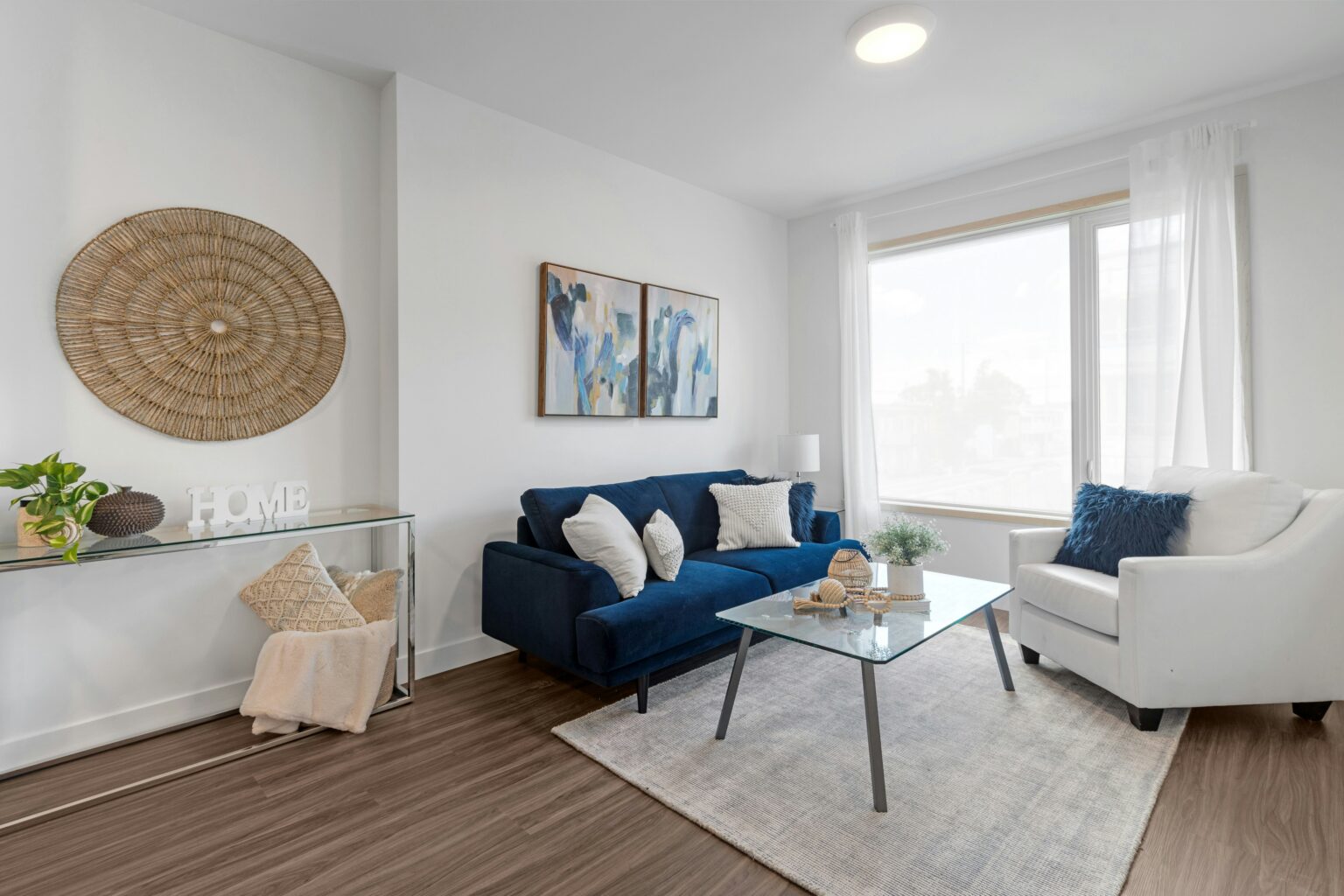 Apartment with a blue and white sofa next to a coffee table. The best cleaning service in Stratham. The best apartment cleaning services in Hampton