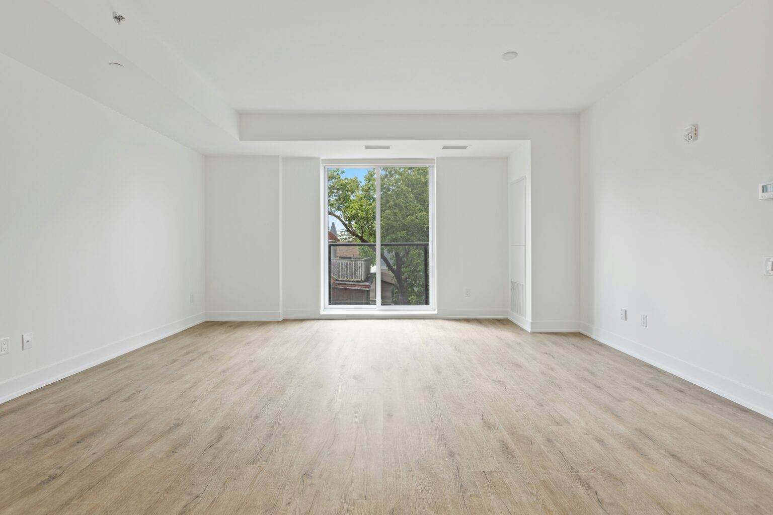 Expert move-in/move-out cleaning in Stratham. Empty room with a sliding door.