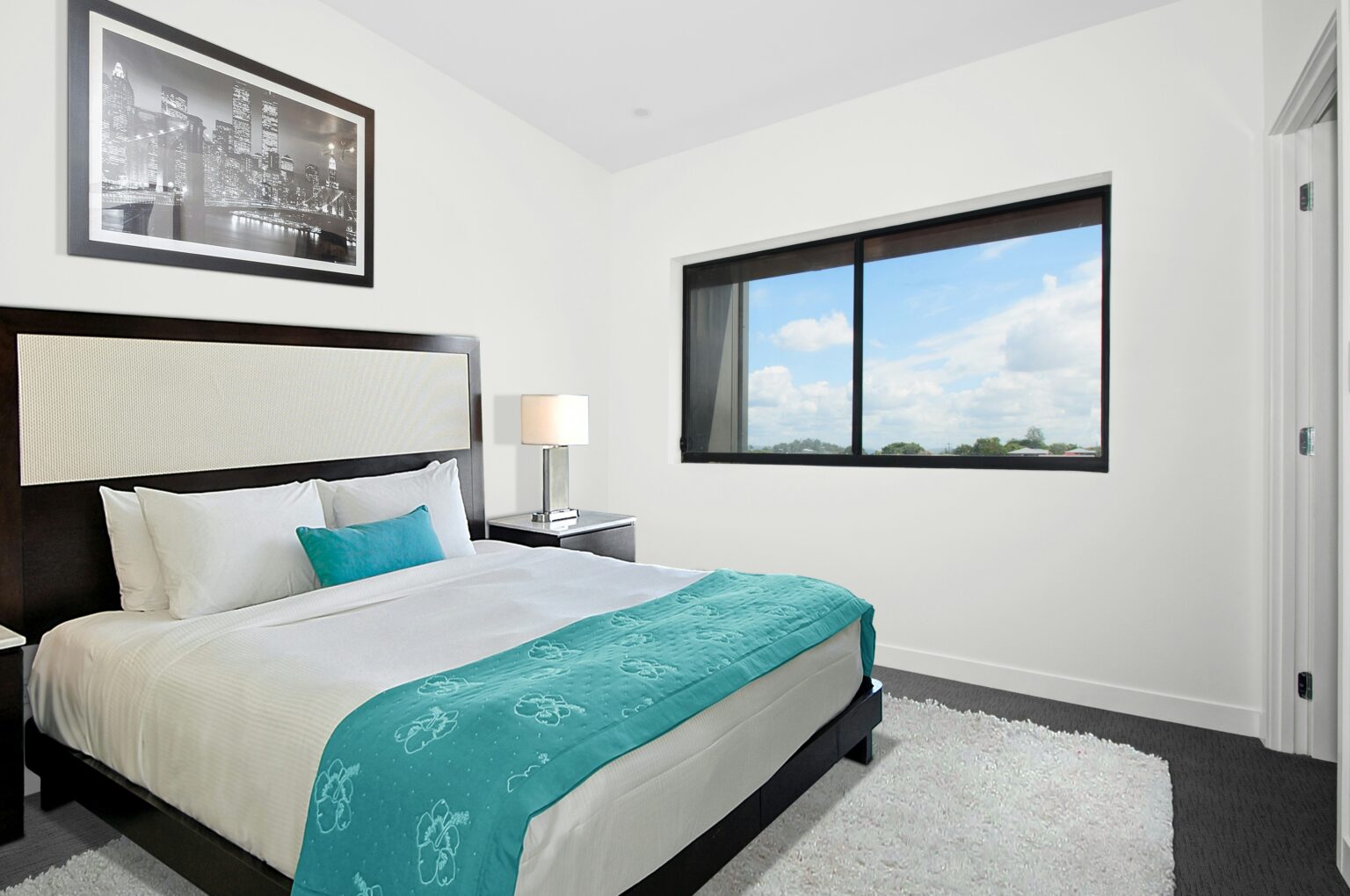 Bedroom freshly cleaned with teal accents