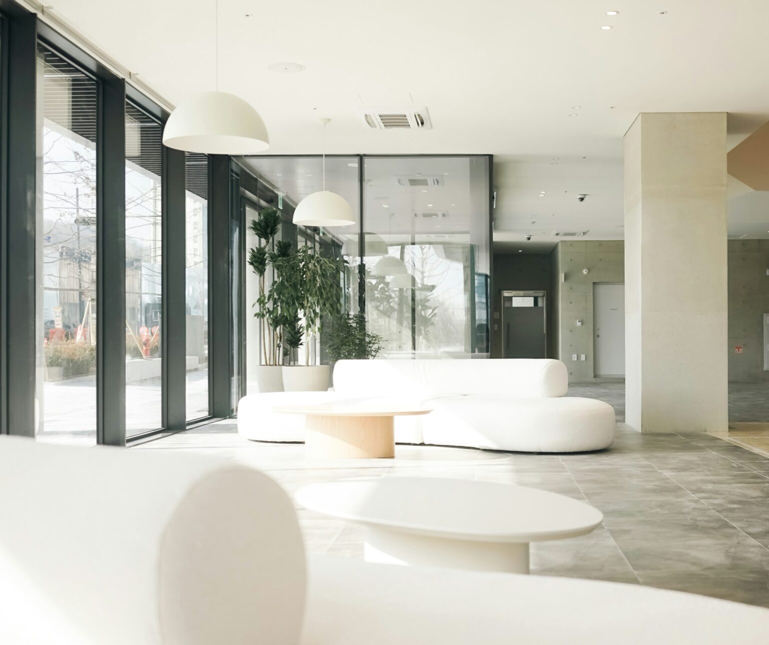 Two couches in a commercial area with large windows to the left