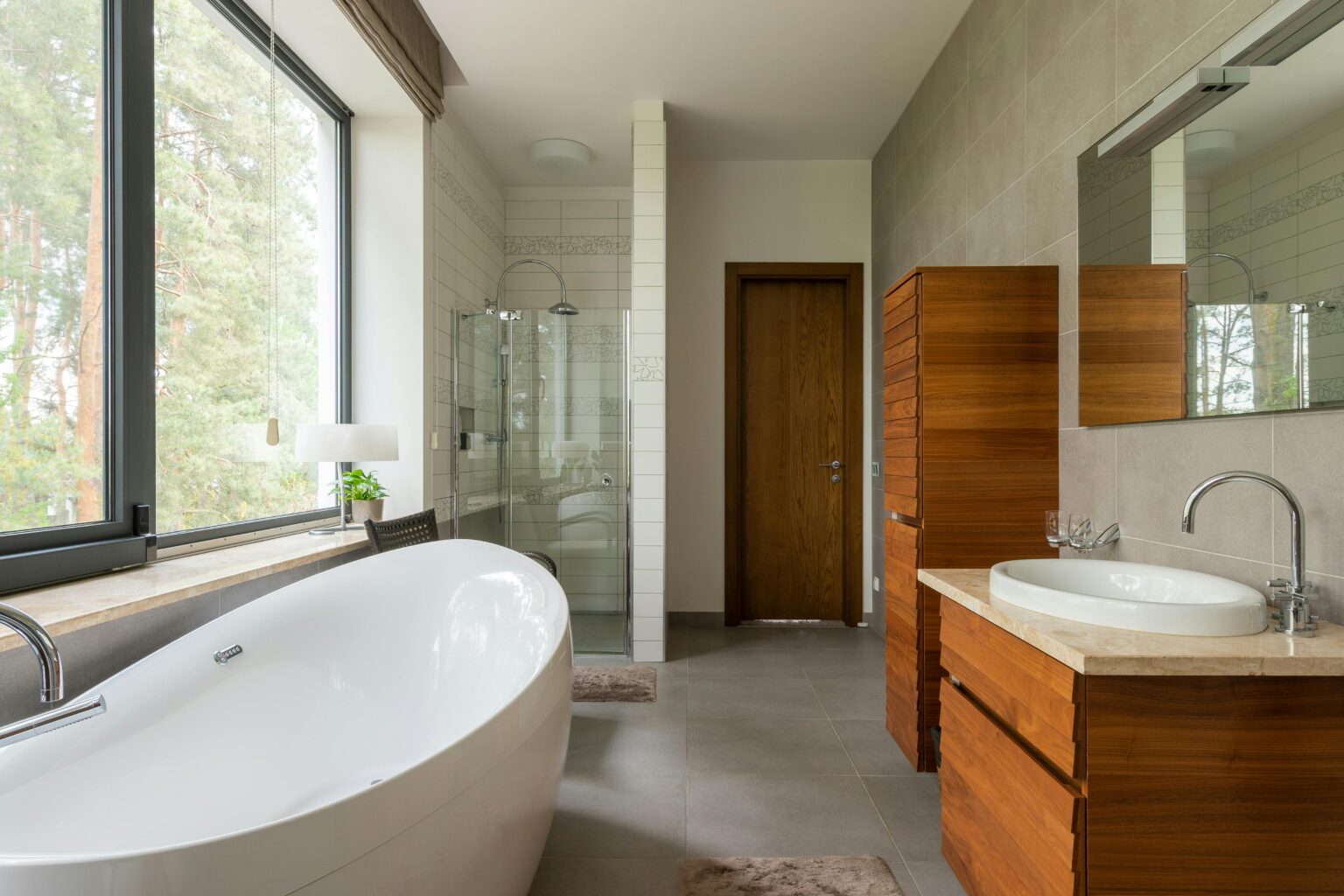 Beautiful bathroom with a wooden vanity and a white tub to the left. Post-construction cleaning services in Seabrook.